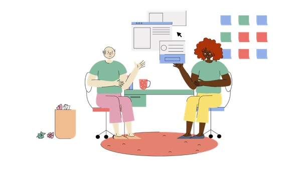 Two people planning, sitting around a table in an office with computer windows floating above them and sticky notes behind t